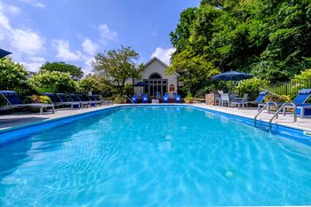 a swimming pool with a house in the background